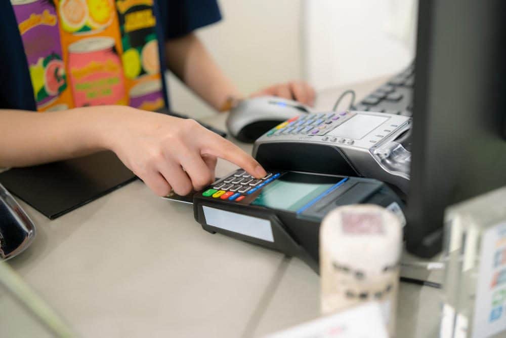 cashier using credit card terminal